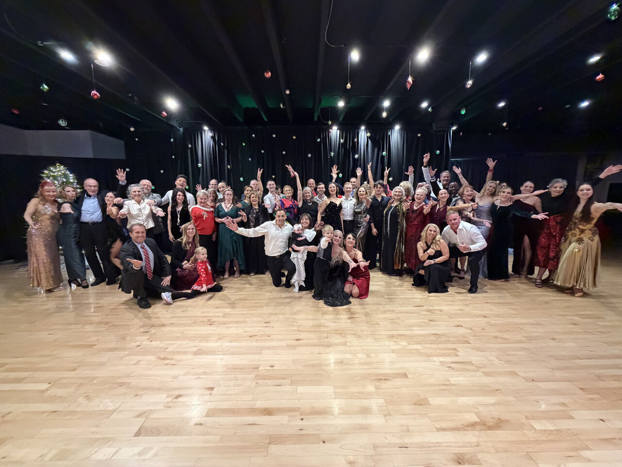 A holiday party of about fifty guests on the Downtown Sarasota ballroom floor