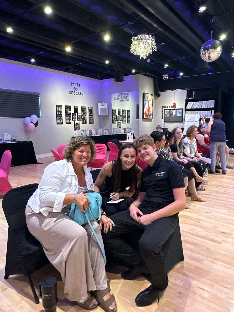 Guests at café tables in the studio lounge during an evening event